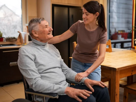 Carer providing gentle memory prompts and routine support for someone with mild cognitive decline