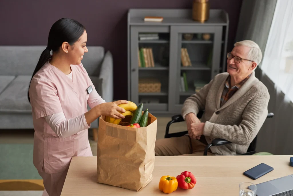 Carer delivering groceries and offering shopping support for an elderly client