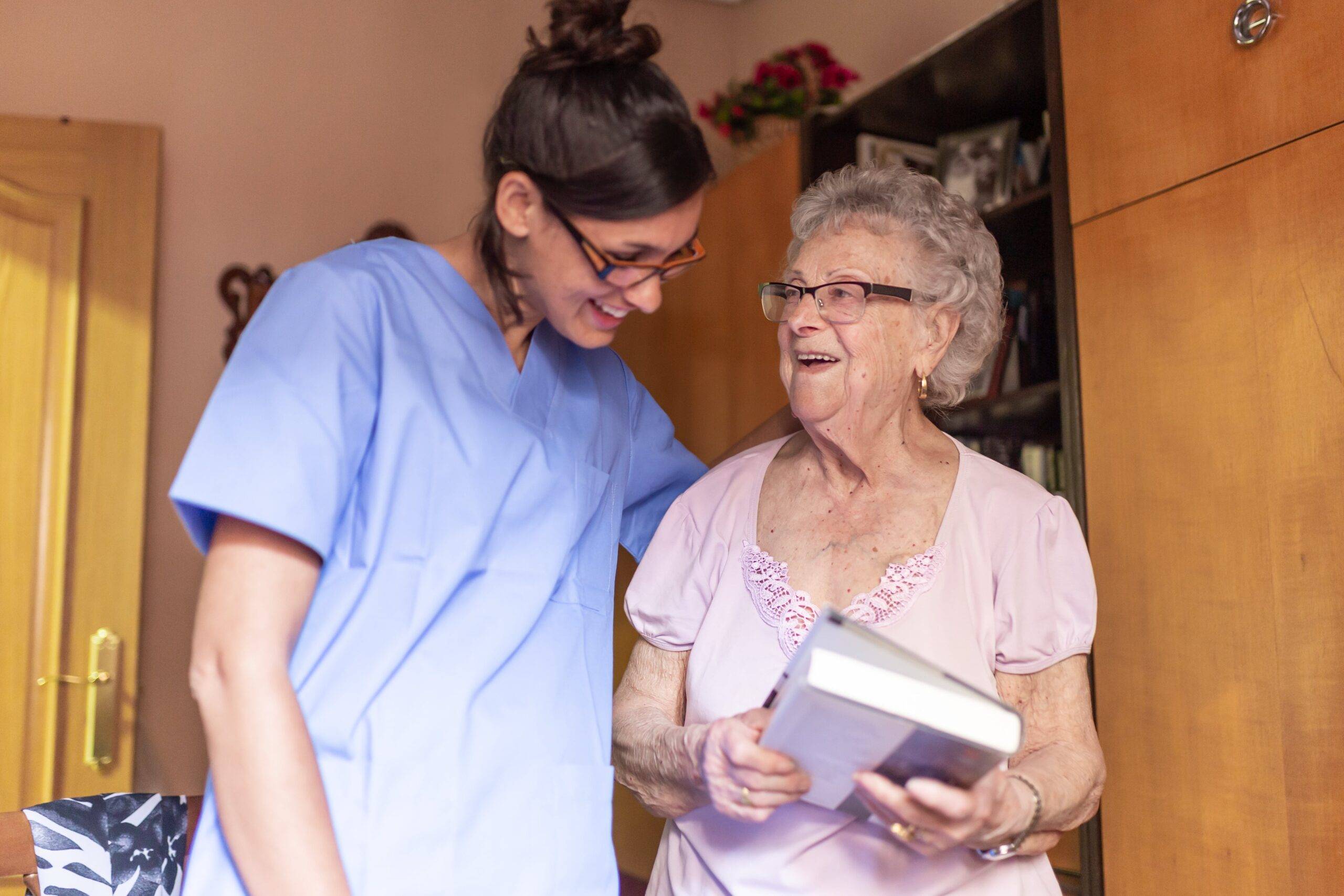 Home carer supporting an older adult in Scotland during a home visit