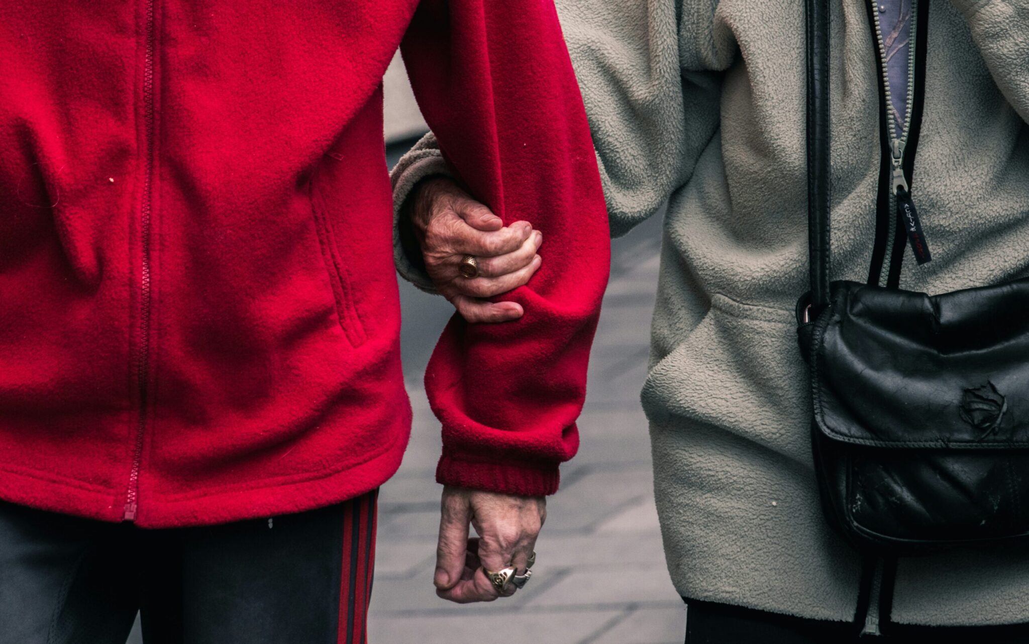 Carer supporting an older adult while shopping