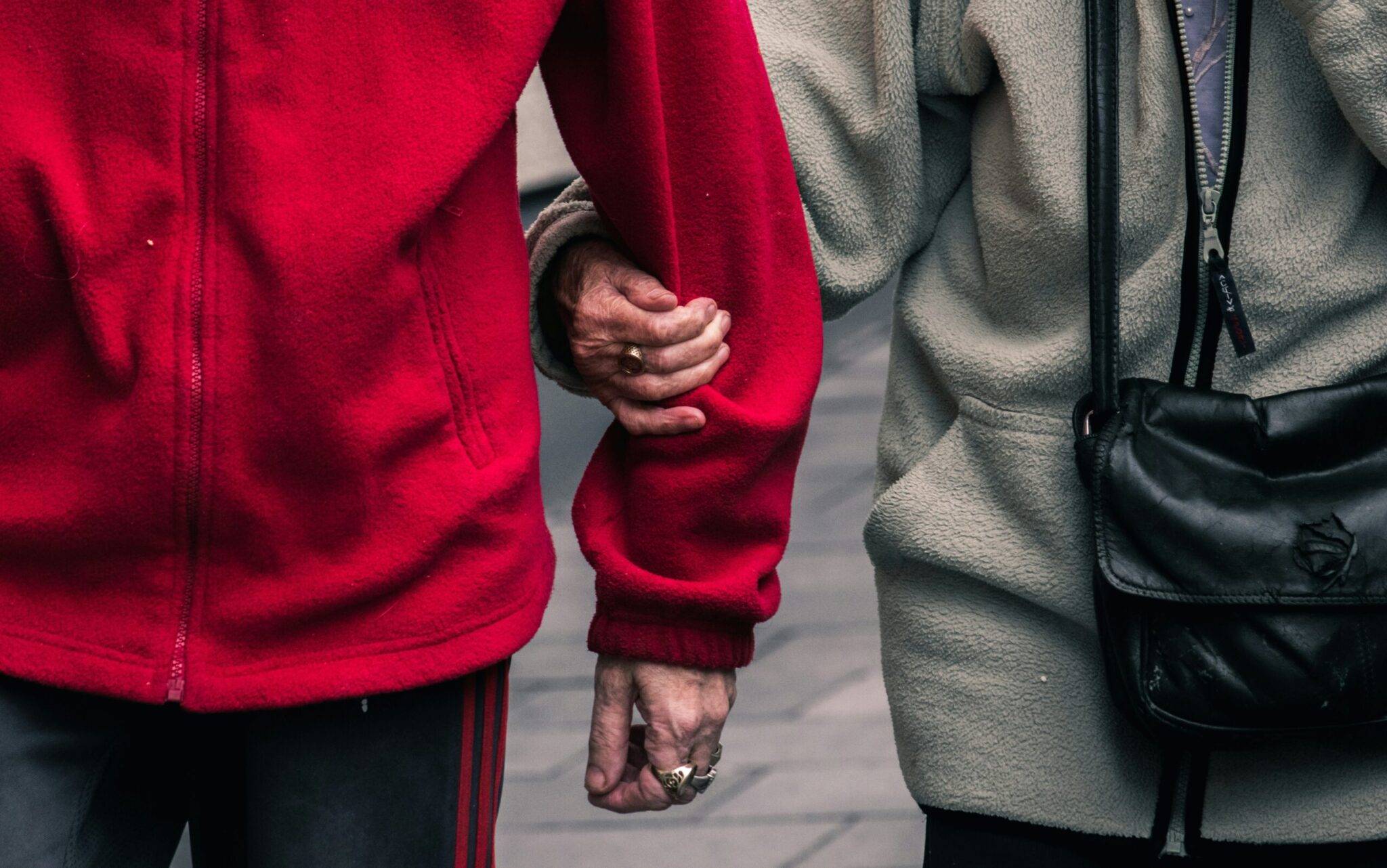 Carer supporting an older adult while shopping